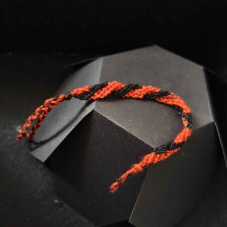 A black and red striped friendship bracelet