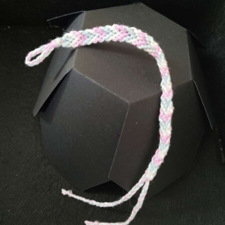 A chevron friendship bracelet in the trans flag colours